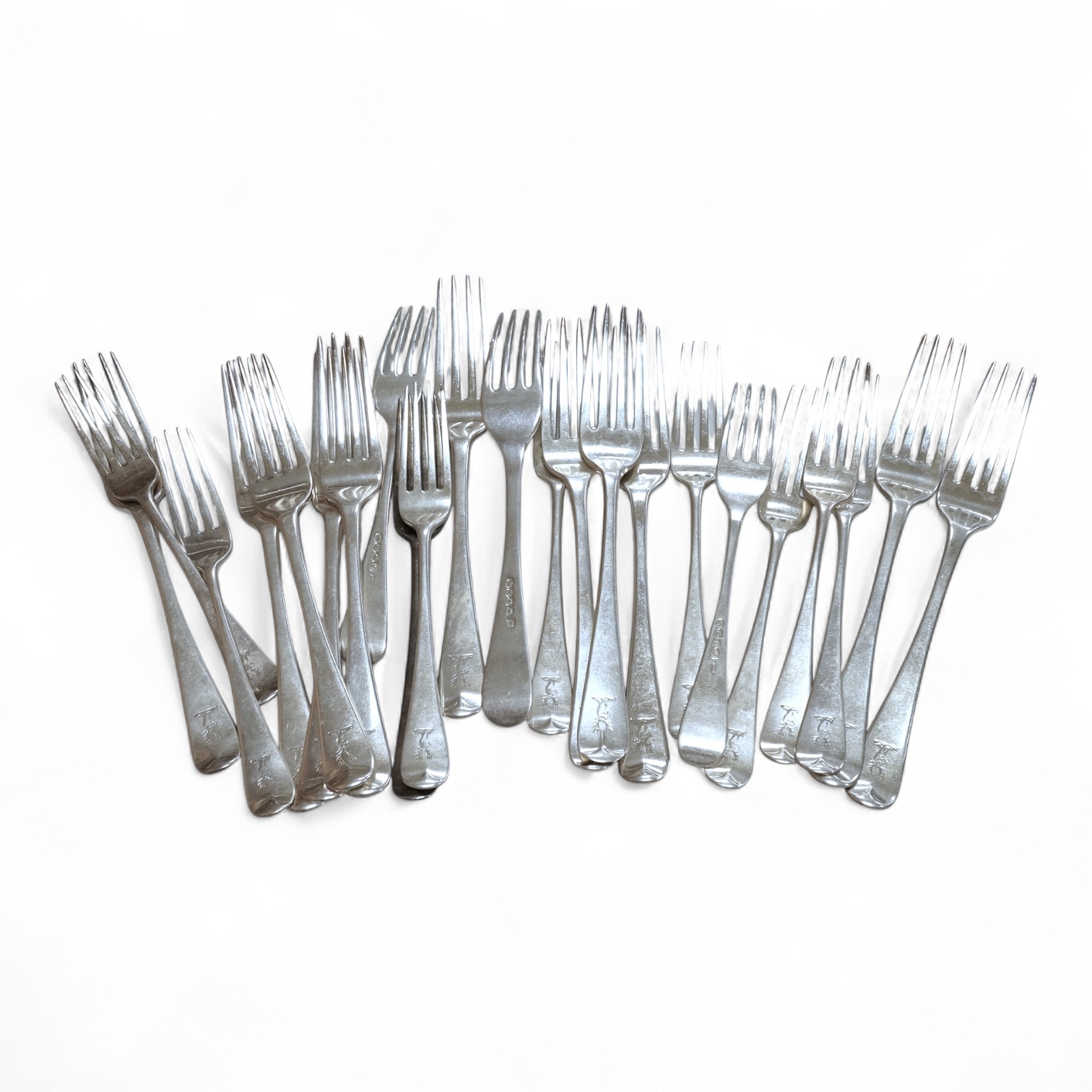A set of eight George IV silver Hanoverian pattern table forks by Eley & Fearn, London, 1821, three other similar table forks and a set of eleven Victorian silver Hanoverian pattern dessert forks, George Adams, London, 1